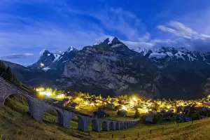 Nighttime Prints: Steep viaduct of funicular above the illuminated village of Murren at night