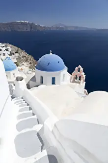 Bell Tower Prints: Steps leading to white church with blue dome overlooking the Caldera, Oia, Santorini