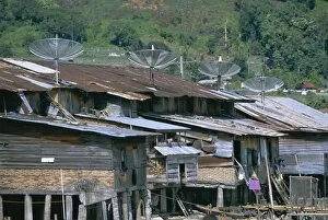 Stilt houses with satellite dishes