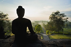 Traditionally Indonesian Prints: Stone Buddha silhouetted at sunrise at Borobudur Temple