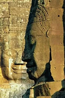 Cambodia Gallery: Stone heads typifying Cambodia on the Bayon Temple at Angkor Wat, Siem Reap