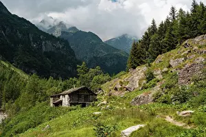 Scenic Landscape Prints: Stone hut in an alpine forest on a hiking trail in Alagna Valsesia area in the Italian Alps