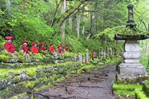 Cloth Prints: Stone jizo statues with red clothing along Kanmangafuchi Abyss under green trees in Nikko Tochigi Japan