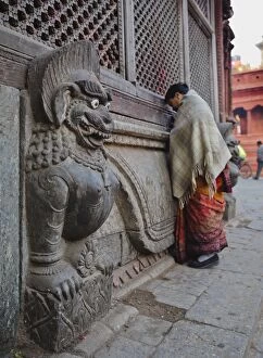 Stone lions guard a prayer wall in Durbar Square, Kathmandu, Nepal, Asia