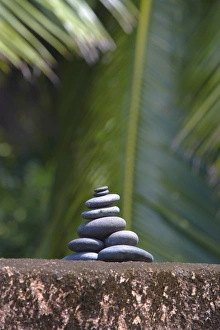Images Dated 30th June 2008: Stones balanced on rock, palm trees in background, Maldives, Indian Ocean, Asia