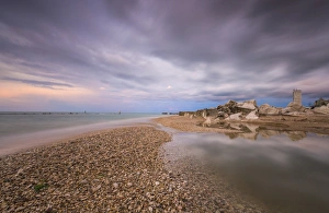 Marche Prints: Storm clouds are reflected in the clear water at sunset