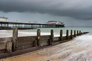 Norfolk Prints: A stormy sky over the beach and pier at Cromer, Norfolk, England, United Kingdom, Europe