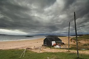 Images Dated 8th October 2007: Stormy sky with fishermans hut and net drying poles, Redpoint beach