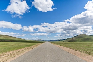 Mongolian Prints: Straight road in the Mongolian steppe and clouds in the sky, North Hangay province