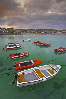 Images Dated 9th July 2008: Strange cloud formation in a stormy sky at sunset, with small red speedboats for hire with an