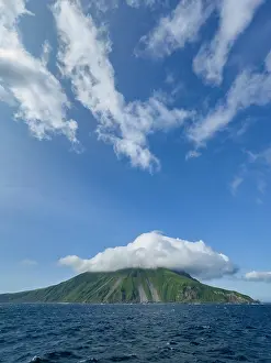 Alaska Prints: Stratovolcano rises on Kagamil Island in the Aleutian Archipelago of Alaska with green slopes and blue skies