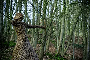 Woodland Prints: Straw sculpture of a humanoid figure in a forest