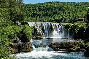 Cascading Prints: Strbacki buk waterfall cascades through green landscape in Una National Park Bosnia and Herzegovina