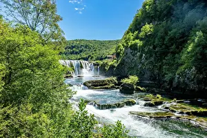 National Prints: Strbacki buk waterfall flows through Una National Park in Bosnia and Herzegovina on a sunny day