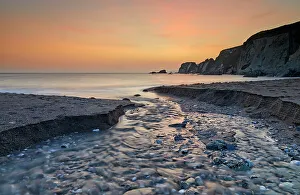 Kingsbridge Prints: A stream cuts across sand as it reaches the sea