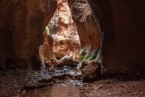 Granada Prints: Stream flows through narrow rock chamber in Barranco de Luna during daylight in Granada region of Spain