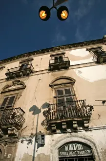 Ortigia Prints: Street lights overlooking a grocers store in the narrow streets of the old city of Ortigia