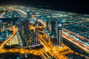 Typically Middle Eastern Prints: The street lights and skyscrapers of Dubai are seen at night from high above the city