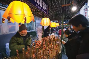 A street market selling local snacks and sweet hawthorne on sticks, Daoliqu area