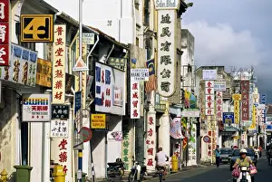 Penang Prints: Street scene with shop signs in Chinatown in the centre of Georgetown
