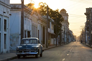 Road Markings Prints: Street scene at sunrise with vintage American car