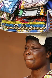 Carrying Prints: Street vendor selling African cloths, Lome, Togo, West Africa, Africa