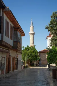 Walkway Prints: Street view in Kaleici with a prominent minaret under clear skies in Antalya, Turkey