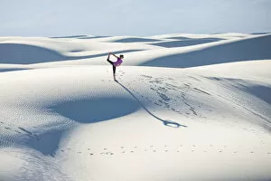 35 39 Years Gallery: Stretching with a yoga pose in White Sands National Park, New Mexico