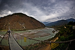 A student crosses Bhutans longest suspension bridge, Panakha, Bhutan A student crosses Bhutans longest suspension bridge, Panakha, Bhutan