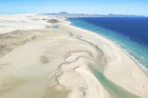 Sand Beach Prints: Stunning aerial shot capturing the winding sandy shores and turquoise waters of Sotavento Beach in Fuerteventura
