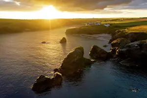 Warmth Prints: Summer sunrise over Porthcothan Bay on the North Cornwall coast, Cornwall, England