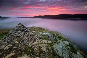 Summit Cairn on Yew Crag above misty Ullswater at sunrise, Gowbarrow Fell, Lake District National Park