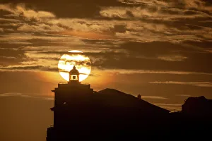 Lighthouses Prints: Sun aligned with the silhouette of the lighthouse of Luarca, Asturias, Spain, Europe