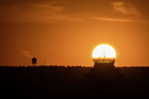 Airport Prints: The sun aligned at sunrise with an airport control tower, Spain, Europe