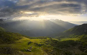 Farms Prints: Sun filters between clouds at sunrise with illuminated pasture, Valmalenco, Valtellina