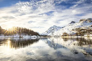 Engadine Prints: The sun illuminates the icy surfaces of Lake Sils, Engadine Valley, Graubunden