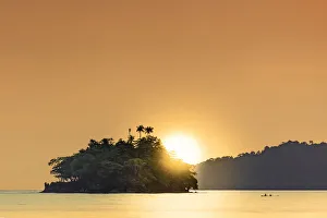 Fisherman Prints: The sun setting behind islets in the Banda archipelago, Banda, Maluku, Spice Islands