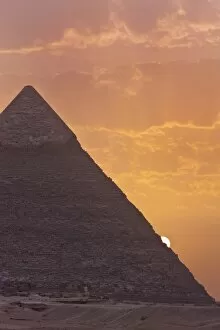 The sun setting behind the Pyramid of Khafre in Giza, UNESCO World Heritage Site, near Cairo, Egypt, North Africa