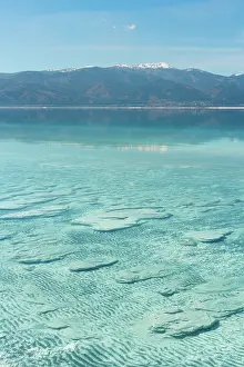 Recreational Prints: Sun shines on Salda Lake revealing stromatolites in turquoise water on a clear day in Turkey