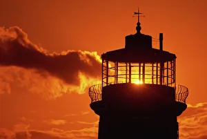Dramatic Skies Prints: Sun shining through lantern room of Belle Tout, disused lighthouse, Beachy Head