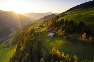 Sunbeam Prints: Sunbeam at sunset lighting the warm colors of autumn in Funes Valley, aerial view