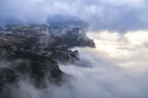 Sexten Dolomites Prints: Sunlight over Croda dei Toni through the autumn fog covering Auronzo Valley