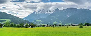 Meadows Prints: Sunny day over the green fields and mountains in Austria near Saalfelden with clear skies and rural scenery