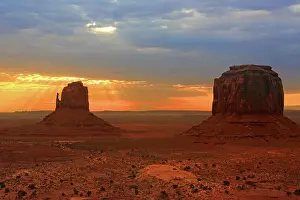Iconic Prints: Sunrise casts light over Monument Valley in Navajo Indian Territory Utah in the early morning hours