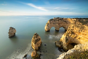 Lagoa Municipality Prints: Sunrise on cliffs framed by turquoise water of the ocean, Praia da Marinha, Caramujeira