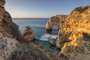 Lagoa Municipality Prints: Sunrise on the cliffs and turquoise water of the ocean, Praia da Marinha, Caramujeira