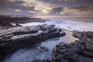 Porthcawl Prints: Sunrise over the dramatic rocky coastline of Porthcawl in winter, South Wales