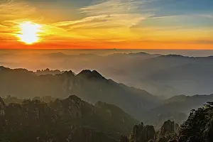 Wonders Prints: Sunrise over Huangshan Mountain showcasing layers of hills and a bright sky in Anhui Province