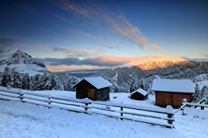 Winter Scene Prints: The sunrise lights up the snowy woods and huts