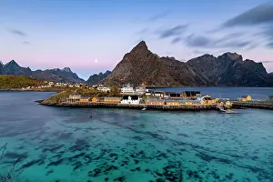 Sakrisoy Prints: Sunrise over Olstind mountain and fishing village of Sakrisoy overlooking the cold blue sea